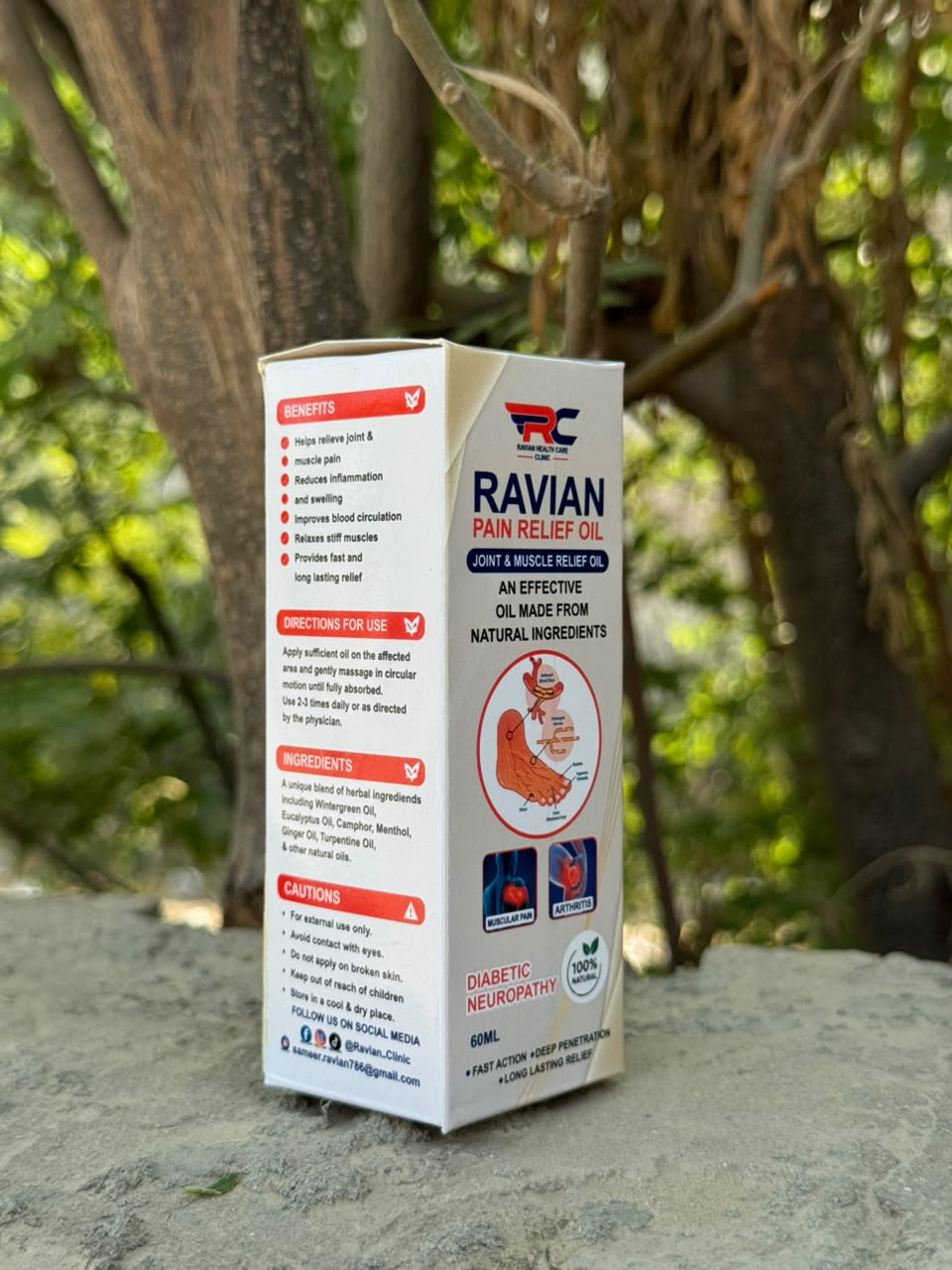 Ravian Pain Relief Oil box in an outdoor setting